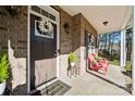 Close up of the covered front porch featuring a welcoming entrance, seating, and a charming wreath at 1196 Hummingbird Ln, Rock Hill, SC 29732