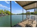 Covered boat dock includes seating and a ladder for easy water access at 141 Baywatch Dr, Mooresville, NC 28117