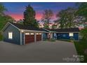 Charming blue home with a spacious driveway and a two-car garage at 141 Baywatch Dr, Mooresville, NC 28117