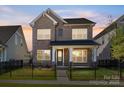 Charming two-story brick home with a fenced front yard and covered porch at 17021 Malone Ln, Mint Hill, NC 28227