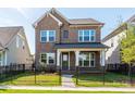 Charming two-story brick home with a fenced front yard and covered porch at 17021 Malone Ln, Mint Hill, NC 28227