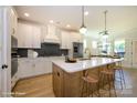 Bright kitchen features a large island with seating, stainless steel appliances and modern finishes at 17021 Malone Ln, Mint Hill, NC 28227