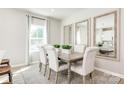 Bright dining area boasts seating for six, complemented by elegant mirrors at 2159 Primm Farms Dr # C, Charlotte, NC 28216