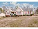 Well-maintained single-Gathering home boasts red shutters, landscaping, and a spacious front yard on a sunny day at 292 Miller Farm Rd, Statesville, NC 28625