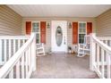 Charming front porch featuring rocking chairs and decorative accents, perfect for relaxing and enjoying the outdoors at 292 Miller Farm Rd, Statesville, NC 28625