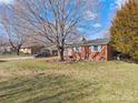 Quaint brick ranch-style home with a spacious front yard and mature shade trees at 3204 Starrland Dr, Gastonia, NC 28052