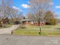 Charming brick ranch-style home featuring a fenced yard, carport, and beautiful curb appeal at 3204 Starrland Dr, Gastonia, NC 28052