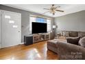 Cozy living room with hardwood floors, a large TV, and a comfortable sectional sofa at 3204 Starrland Dr, Gastonia, NC 28052