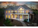 Brick home featuring a walkout basement, a stone pathway, a balcony, and a covered patio with outdoor seating at 4164 54Th Ne Ave, Hickory, NC 28601