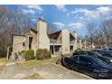 Charming townhouse featuring a cozy entrance, complemented by lush greenery and convenient street parking at 4400 Sharon Chase Dr, Charlotte, NC 28215