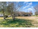 Single story home surrounded by mature trees on a manicured lawn at 706 Skinner Rd, Shelby, NC 28152