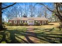 Beautiful brick home with manicured lawn and a classic brick walkway to the front door at 924 S Main Ave, Newton, NC 28658