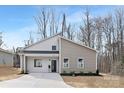 Beautiful single Gathering home with light grey and beige vinyl siding, black trim, and welcoming covered entryway at 935 Junius St, Gastonia, NC 28052