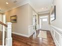 Spacious foyer with hardwood floors, white wainscoting, and plenty of natural light at 10000 Dressage Ln, Midland, NC 28107