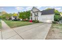 A well-maintained two-story home with a manicured lawn and a spacious driveway at 10230 Blackstock Rd, Huntersville, NC 28078