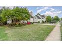 A charming two-story home with mature trees and a well-maintained lawn in a suburban neighborhood at 10230 Blackstock Rd, Huntersville, NC 28078