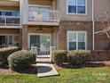 Charming two-story condo with a brick facade, a covered patio, a balcony, and a well-manicured front lawn at 103 Pier 33 Dr # 207, Mooresville, NC 28117