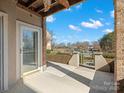 The covered patio offers an inviting space with views of the community and nearby lake at 103 Pier 33 Dr # 207, Mooresville, NC 28117
