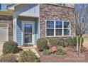Close up of the front door of a well-maintained home with attractive landscaping at 11206 Grenfell Ave, Huntersville, NC 28078
