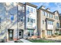 Stately brick townhome showcases a three-story facade with well-maintained landscaping at 1244 Madison Towns Ln, Charlotte, NC 28209