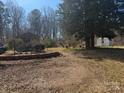 Unkept backyard with outbuildings and overgrown landscaping, a blank canvas to create your dream oasis at 128 Trexler Ave, Mount Holly, NC 28120