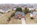 An aerial view showcases the beautiful brick home, surrounded by lush landscaping and mature trees in a quiet neighborhood at 13132 Purple Dawn Dr, Charlotte, NC 28213