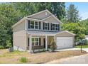 Charming two-story home with a front porch, two-car garage and brick accents at 222 Ventner Ct, Charlotte, NC 28214