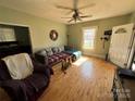 Inviting living room with hardwood floors, comfortable seating, and natural light streaming through the window at 228 Hazeleen Ave, Belmont, NC 28012