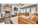 Inviting living room featuring hardwood floors, a fireplace, and comfortable leather furniture at 249 Sand Paver Way, Fort Mill, SC 29708