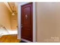Apartment entryway featuring hardwood floors and a secure door with the letter K at 300 S Main St # K, Salisbury, NC 28144