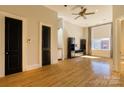 Bright living room with hardwood floors, black accent doors, and a ceiling fan at 300 S Main St # K, Salisbury, NC 28144