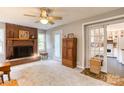 Cozy living room with a brick fireplace, wood cabinet, and a glimpse into the kitchen at 306 W Marsh St, Salisbury, NC 28144