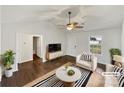 Bright, virtually staged living room with vaulted ceiling, modern furniture, and view to outside at 313 Pelling Dr, York, SC 29745