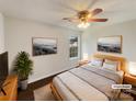 Virtually staged main bedroom with wood-look floors, decor art, and large windows at 313 Pelling Dr, York, SC 29745