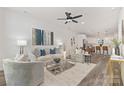 Bright living room featuring modern furniture, stylish decor, and an open floor plan leading to the kitchen at 3907 Oakwood Rd, Charlotte, NC 28269