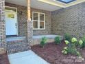 Inviting front porch with brick pillars and tidy landscaping at 404 Imperial Way, Albemarle, NC 28001