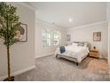 Serene bedroom featuring neutral walls, plush carpet, and a cozy bed with stylish decor at 4548 Millennium Ave, Charlotte, NC 28217