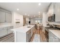 Bright kitchen with stainless steel appliances, large island with sink, and open floor plan at 4548 Millennium Ave, Charlotte, NC 28217