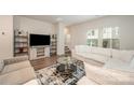 Bright and airy living room with neutral tones, plush seating, and large windows at 4548 Millennium Ave, Charlotte, NC 28217