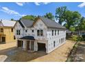 New home build featuring an unfinished garage, multiple windows, and modern architectural design at 507 Bowman Rd, Charlotte, NC 28217