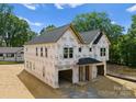 A partially constructed home showcases its modern architectural design and unfinished, attached garage at 507 Bowman Rd, Charlotte, NC 28217