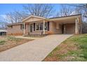 Attractive brick home with a covered porch and a convenient attached carport at 512 Rhodes Ave, Kings Mountain, NC 28086