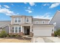 Two story home featuring a two car garage, covered entrance and neutral toned siding at 531 Red Wolf Ln, Clover, SC 29710