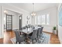 Elegant dining room featuring a wooden table, tufted chairs, and stylish chandelier at 5717 Closeburn Rd, Charlotte, NC 28210