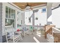 Relax on this covered front porch with rocking chairs and a ceiling fan at 5717 Closeburn Rd, Charlotte, NC 28210