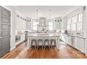 Bright eat-in kitchen features an island with seating, stainless steel appliances and custom cabinetry at 5717 Closeburn Rd, Charlotte, NC 28210