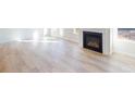 Cozy living room area showcasing a fireplace, lots of light, and hardwood floors at 602 Banter Ln # 28, Cramerton, NC 28032