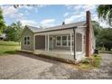 Charming home with neutral siding, chimney and inviting front porch at 621 Bristol Dr, Statesville, NC 28677