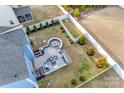 Aerial view of a backyard featuring a custom patio with fire pit and manicured lawn at 634 Gants Rd, York, SC 29745