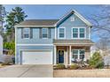 Charming two-story home with a well-manicured front lawn and attached two-car garage at 634 Gants Rd, York, SC 29745